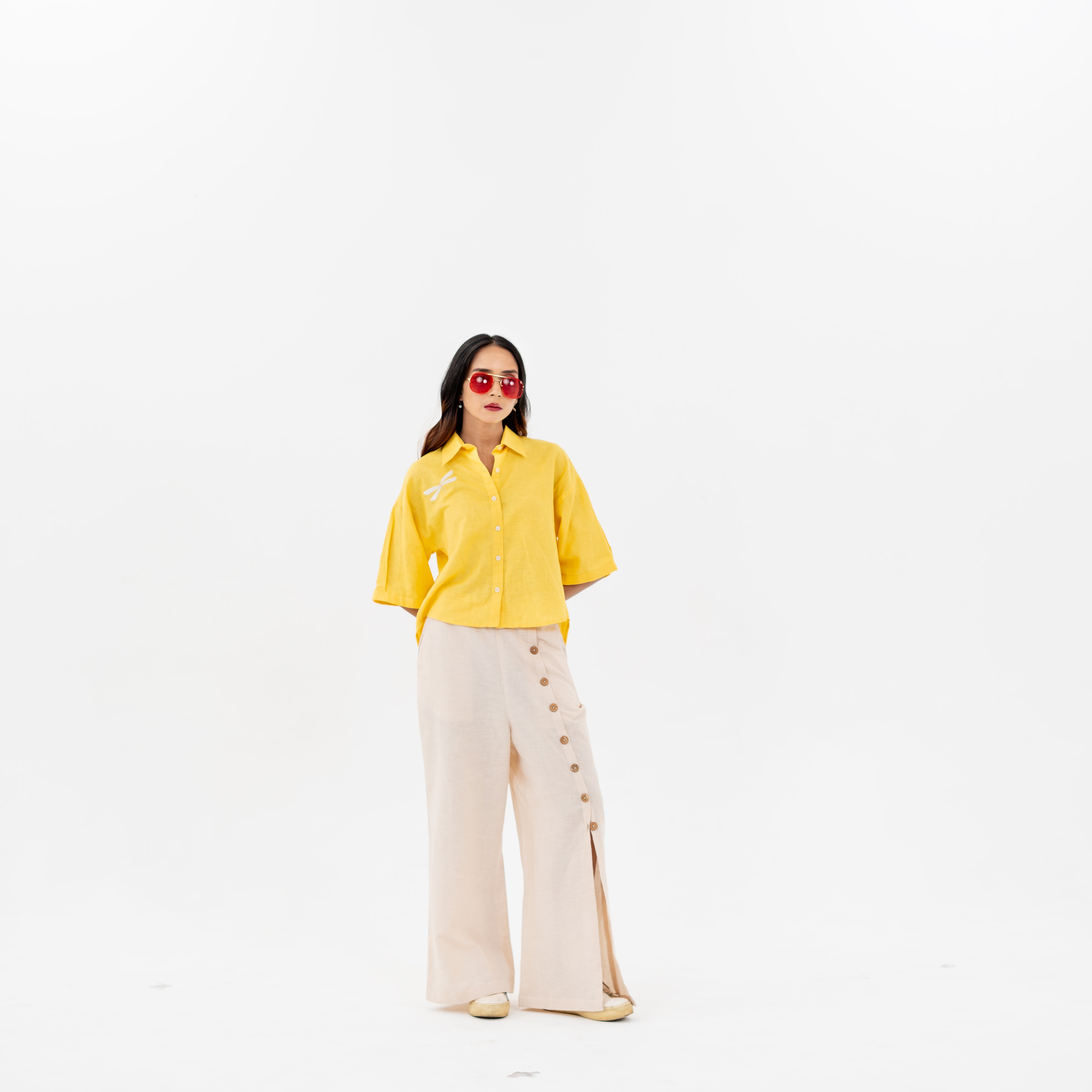 yellow shirt and beige pants on a white background